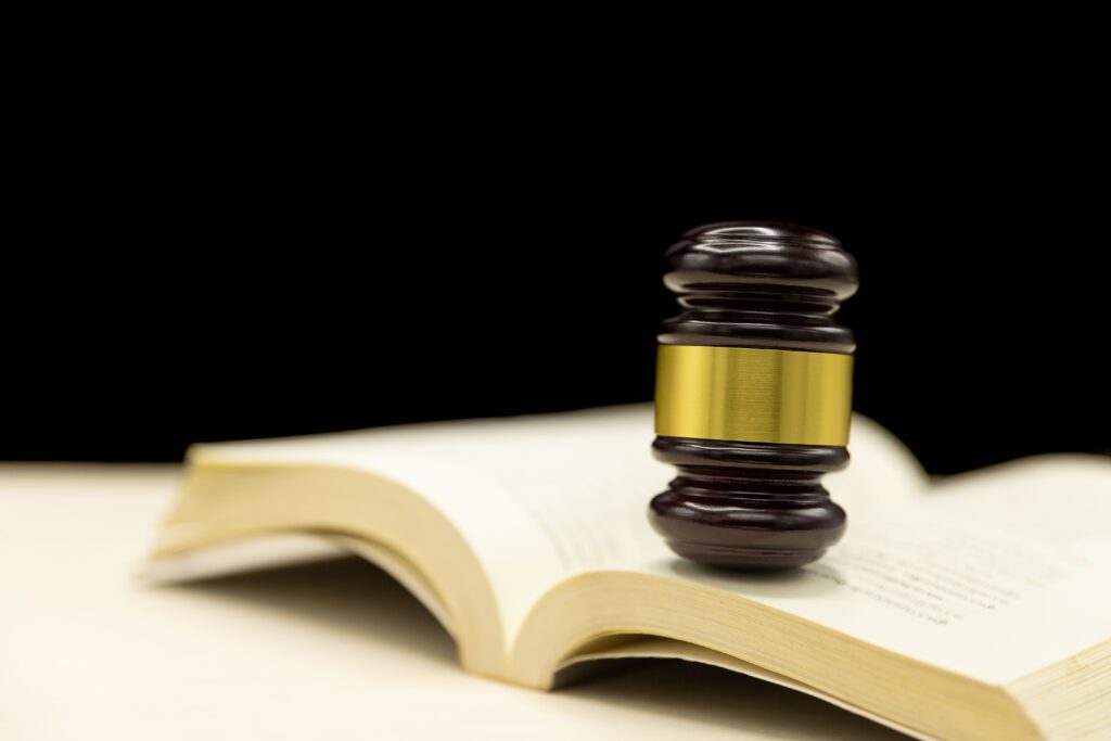 A wooden judge's gavel resting on an open law book symbolizing legal translation, justice, and certified legal services in Dubai. Ideal visual for promoting legal translation in Dubai, Tecom, and Barsha areas, and targeting law firms, legal consultants, and expats needing notarized documents or multilingual legal support.